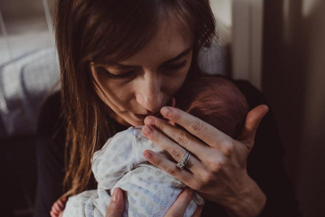 Mother holding new baby to her face during a Perth Fresh 48 photography session captured in home