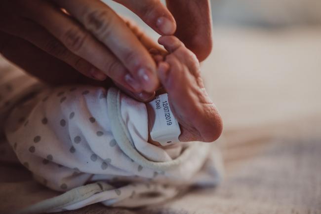 Baby feet with hospital tag during a Perth Fresh 48 photography session captured in home