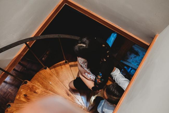 Parents walking up a staircase with their new baby daughter during an in-home Perth Newborn Lifestyle photography session