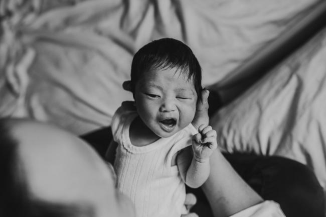 Black and white image of new baby mouthing during an in-home Perth Newborn Lifestyle photography session