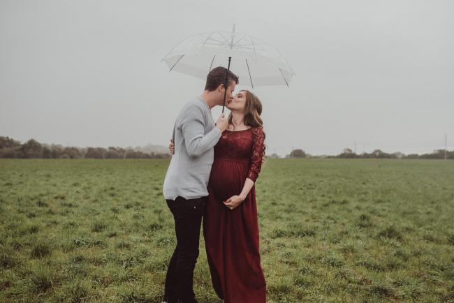 Perth-Maternity-Photographer-Perrys-Paddock-14-of-39 Pregnant couple kissing under an umbrella during a Perth maternity session at Perry's Paddock during rain