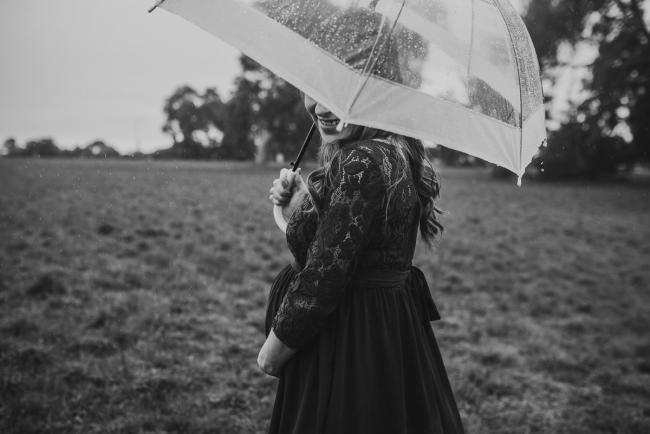 Perth-Maternity-Photographer-Perrys-Paddock-19-of-39 Black and white image of pregnant lady under an umbrella during a Perth maternity session at Perry's Paddock during rain