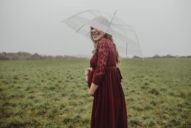 Perth-Maternity-Photographer-Perrys-Paddock-21-of-39 Pregnant lady laughing under an umbrella during a Perth maternity session at Perry's Paddock during rain