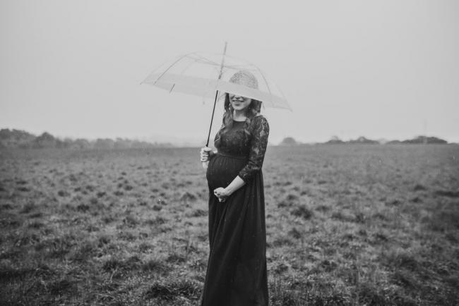 Perth-Maternity-Photographer-Perrys-Paddock-22-of-39 Black and white image of pregnant lady under an umbrella during a Perth maternity session at Perry's Paddock during rain