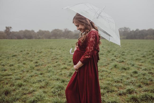 Perth-Maternity-Photographer-Perrys-Paddock-23-of-39 Pregnant lady under an umbrella during a Perth maternity session at Perry's Paddock during rain