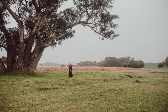 Perth-Maternity-Photographer-Perrys-Paddock-28-of-39 Pregnant lady standing under a tree during a Perth maternity session at Perry's Paddock during rain