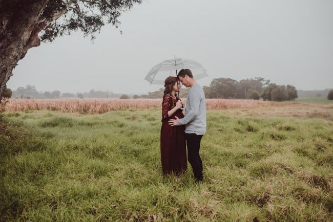Perth-Maternity-Photographer-Perrys-Paddock-30-of-39 Pregnant couple touching foreheads under a tree during a Perth maternity session at Perry's Paddock during rain