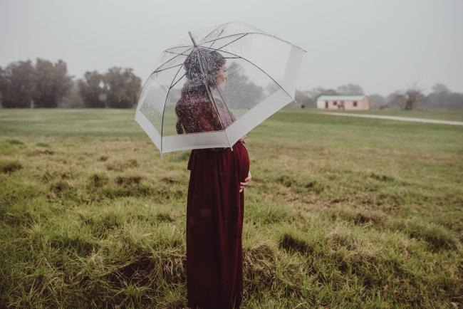 Perth-Maternity-Photographer-Perrys-Paddock-38-of-39 Pregnant lady standing under an umbrella during a Perth maternity session at Perry's Paddock during rain