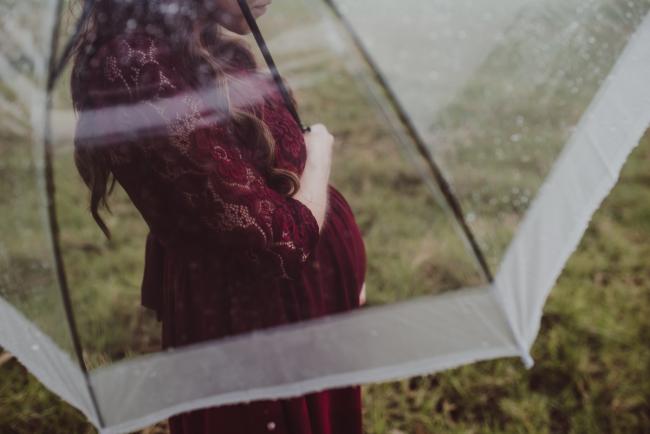 Pregnant tummy under an umbrella with Perth maternity photographer at Perry's Paddock