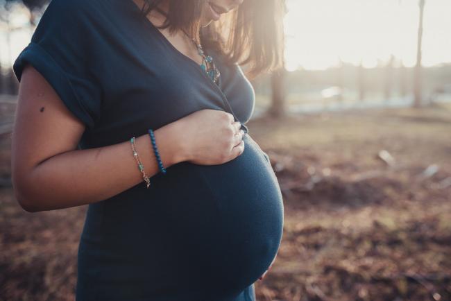 Pregnant woman's tummy with Perth maternity photographer at The Pines