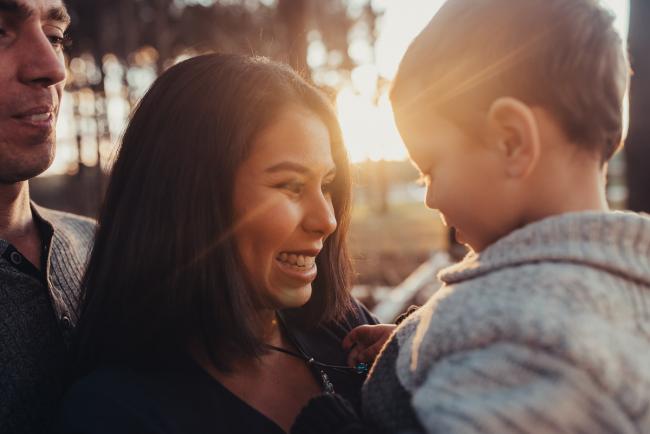 Mother smiling at son with Perth family photographer at The Pines