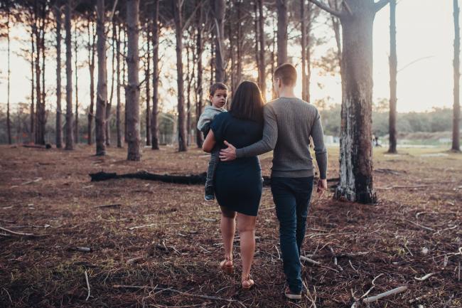 Family of three walking away with Perth family photographer at The Pines