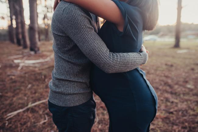 Close up of pregnant couple hugging with Perth maternity photographer at The Pines