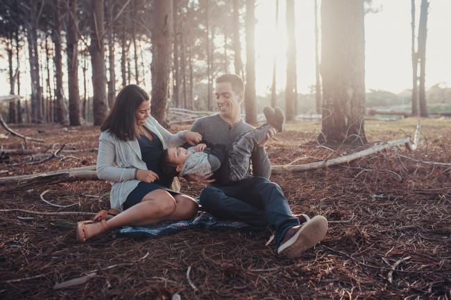 Perth-Maternity-Photographer-The-Pines-6-of-48 Mother and father tickling little boy who is upside down on the rug with Perth maternity photographer at The Pines