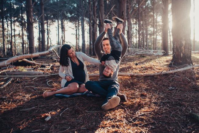 Perth-Maternity-Photographer-The-Pines-7-of-48 Father holding little boy upside down as mother smiles next to them with Perth maternity photographer at The Pines