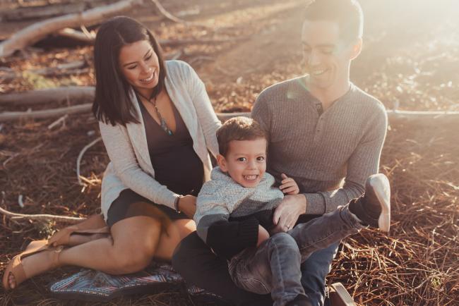 Perth-Maternity-Photographer-The-Pines-8-of-48 Little boy laughing on his father's lap with Perth maternity photographer at The Pines