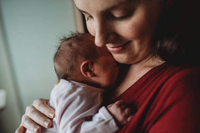 Close up of baby resting against mother's chest during a Perth Fresh 48 photography session at SJOG Mt Lawley