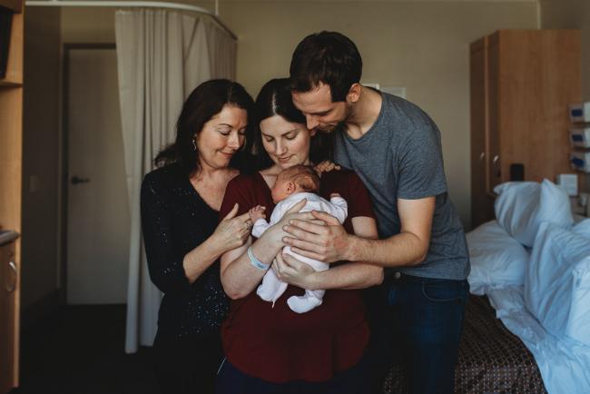 Mother, father and grandmother embracing around new baby during a Perth Fresh 48 photography session at SJOG Mt Lawley