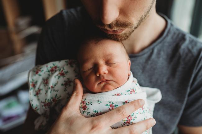 Father's chin resting on new baby during a Perth Fresh 48 photography session at SJOG Mt Lawley