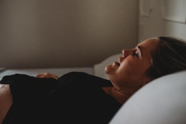 Pregnant woman on a hospital bed with Perth birth photographer at the Family Birthing Centre
