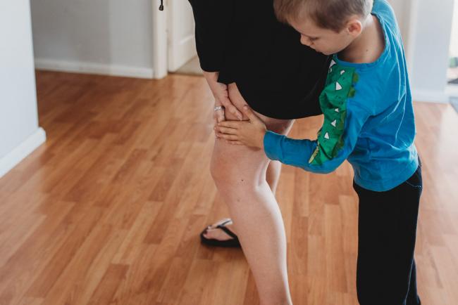 Little boy holding hands with his mother in labour with Perth Birth Photographer