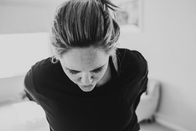 Black and white image of pregnant woman breathing through a contraction with Perth Birth Photographer