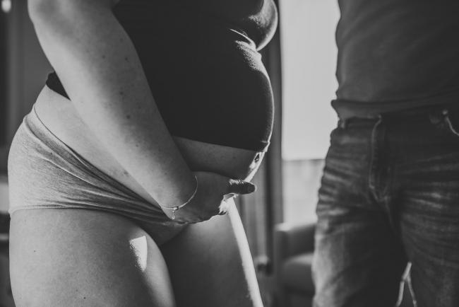 Black and white image of pregnant tummy with Perth Birth Photographer at SJOG Mt Lawley