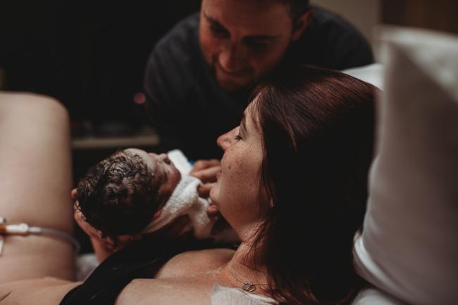 Birth-Photographer-Perth-2-of-60 Father holding newborn baby to mother with Perth Birth Photographer at SJOG Mt Lawley