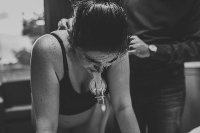 Birth-Photographer-Perth-31-of-60 Black and white image of pregnant woman using gas during contraction with Perth Birth Photographer at SJOG Mt Lawley
