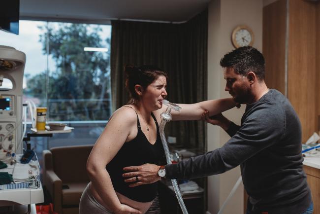 Birth-Photographer-Perth-37-of-60 Pregnant woman in pain during contraction as partner holds onto her with Perth Birth Photographer at SJOG Mt Lawley