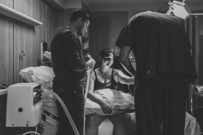 Birth-Photographer-Perth-40-of-60 Black and white image of pregnant mother on bed getting IV drip put in with Perth Birth Photographer at SJOG Mt Lawley