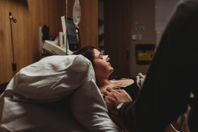Pregnant woman on hospital bed with Perth Birth Photographer at SJOG Mt Lawley