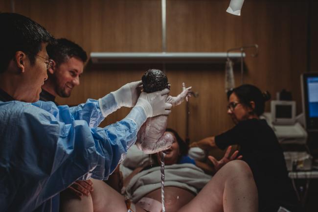 New baby being born with Perth Birth Photographer at SJOG Mt Lawley