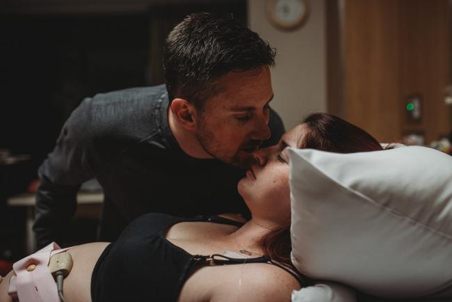 Birth-Photographer-Perth-50-of-60 Man kissing his labouring partner with Perth Birth Photographer at SJOG Mt Lawley