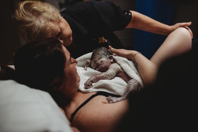 Newborn baby on mother's chest with Perth Birth Photographer at SJOG Mt Lawley