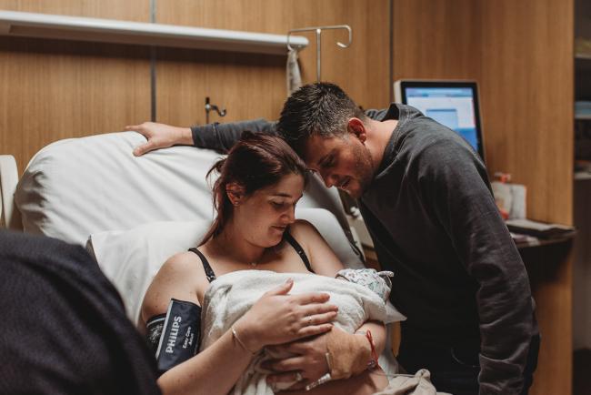 Birth-Photographer-Perth-8-of-60 New parents looking down at their new baby with Perth Birth Photographer at SJOG Mt Lawley