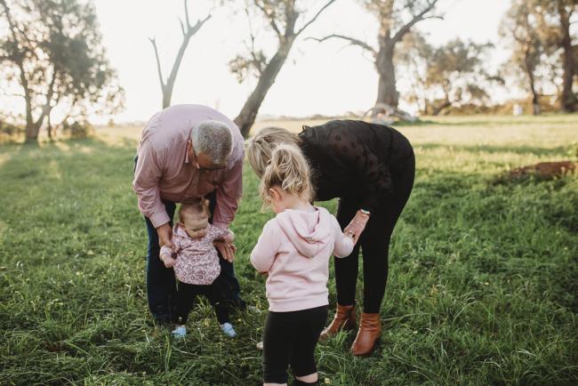 Grandparents holding granddaughters during Perth family photography session at Perry's Paddock during golden hour