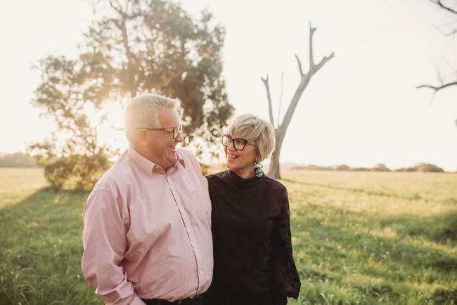 Man and woman smiling at each other during Perth family photography session at Perry's Paddock during golden hour
