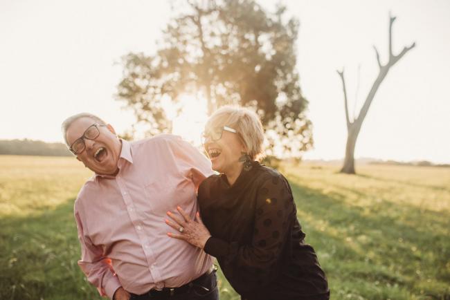 Man and woman laughing during Perth couples photography session at Perry's Paddock during golden hour