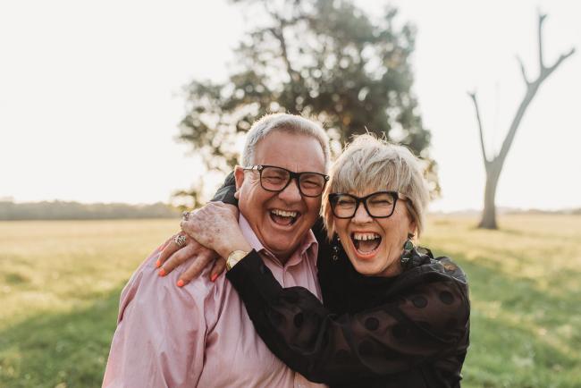 Man and woman laughing during Perth family photography session at Perry's Paddock during golden hour