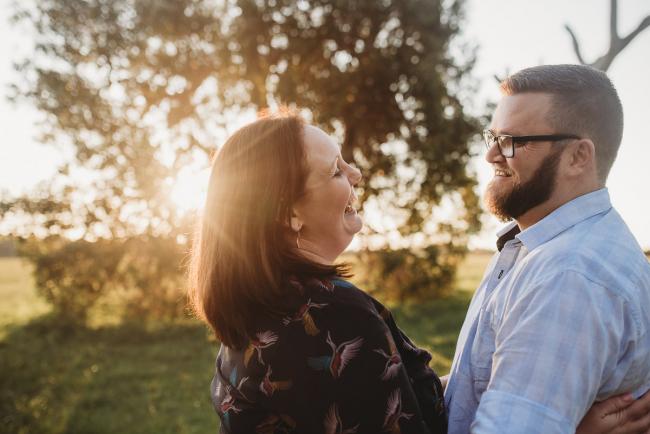 Man and woman laughing during Perth family photography session at Perry's Paddock during golden hour