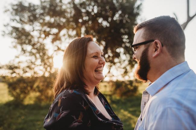 Man and woman laughing during Perth family photography session at Perry's Paddock during golden hour