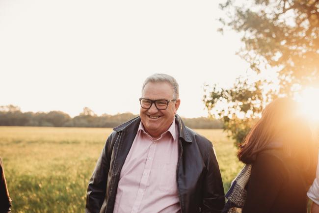 Man smiling during Perth family photography session at Perry's Paddock during golden hour