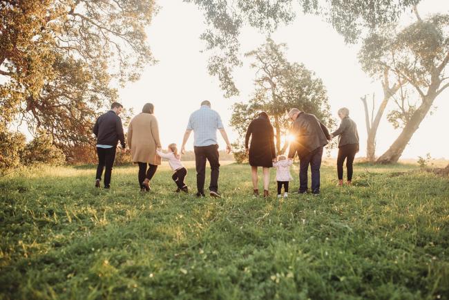 extended family walking away during Perth family photography session at Perry's Paddock during golden hour