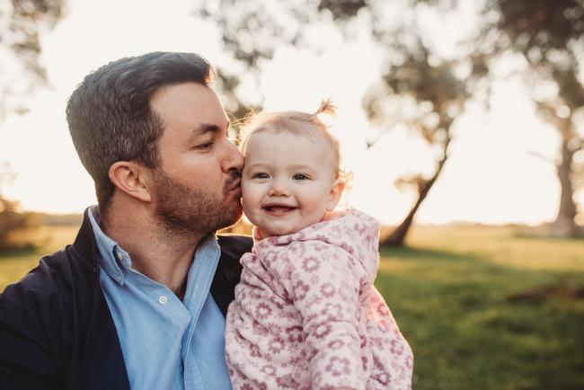 Man kissing little girl during Perth family photography session at Perry's Paddock during golden hour