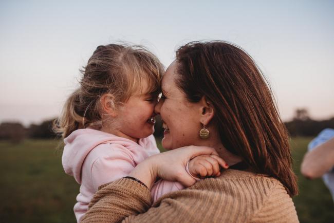 Mother nose to nose with her daughter during Perth family photography session at Perry's Paddock during golden hour