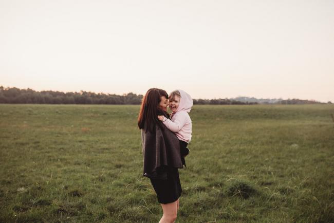 Woman holding little girl during Perth family photography session at Perry's Paddock during golden hour
