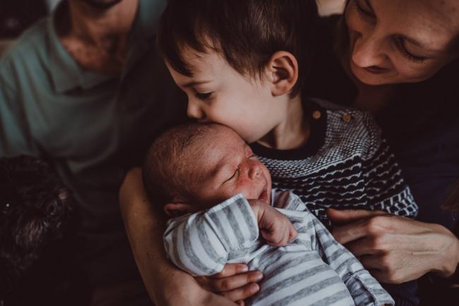 Little boy kissing his baby brother with Lifestyle Newborn Photographer Perth