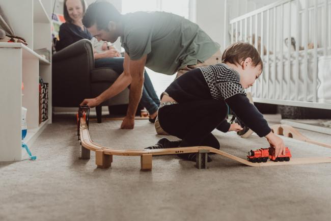 Father and son playing with trains with family photographer Perth