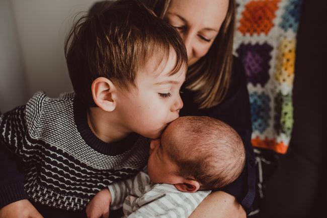 Little boy kissing baby brother with Lifestyle Newborn Photographer Perth